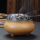 Ceramic Buddha incense burner with antique copper lid, perfect for sticks, cones, or coils. Enhances meditation, rituals, and home décor.
