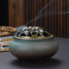 Ceramic Buddha incense burner with antique copper lid, perfect for sticks, cones, or coils. Enhances meditation, rituals, and home décor.
