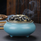 Ceramic Buddha incense burner with antique copper lid, perfect for sticks, cones, or coils. Enhances meditation, rituals, and home décor.