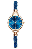 Watch with blue dial and beaded strap with rose gold case on white background.