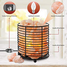 Cylindrical Himalayan salt lamp with iron frame emitting warm light for relaxation and air purification