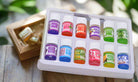 Box of 12 aromatherapy oil bottles featuring floral and fruity scents