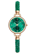 Watch with green dial and beaded strap with rose gold case on white background.