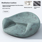 Round ergonomic meditation cushion placed on a yoga mat, with a serene background of plants and candles