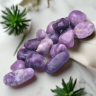 Tumbled Lepidolite healing crystals in polished purple geometric shapes, 100g