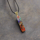 "Colorful chakra stone pendant on a sleek leather strap."