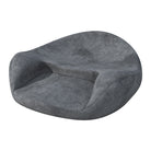 Round ergonomic meditation cushion placed on a yoga mat, with a serene background of plants and candles