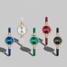 Five decorative watches with colorful dial and  straps on a gray background