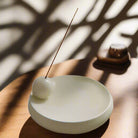 "Elegant ceramic incense holder with modern minimalist design."