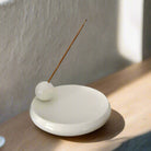 "Elegant ceramic incense holder with modern minimalist design."